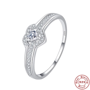 Detailed macro of S925 sterling silver ring with heart-shaped stone and crossover band