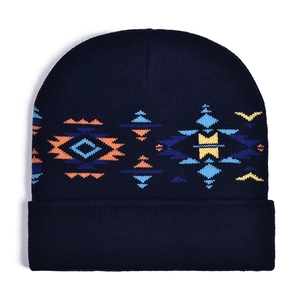 Detailed view of the dark blue knit beanie featuring colorful geometric tribal patterns