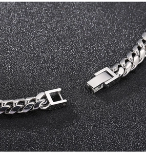 Macro shot of silver stainless steel Cuban link necklace with professional clasp detail