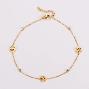 Detail of tree of life anklet with gold circular pendants and sparkling zircon accents