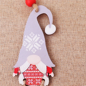Close-up of painted wooden gnome ornament with red hat and natural jute rope hanging loop