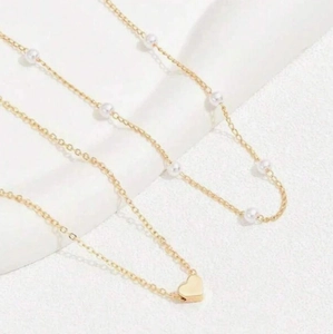 Elegant layered gold-plated pearl necklace featuring a minimalist heart pendant design