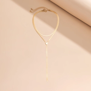 Detail of gold double-layered choker with snake chain and triangular pendant