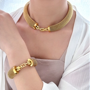 Chunky gold mesh chain necklace and bracelet set in luxury 18K gold finish on a model