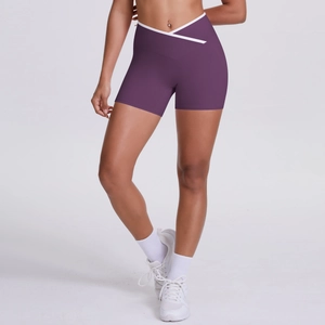 Detail of high-waisted yoga shorts featuring cross V-waist design and white contrast trim