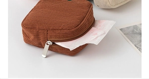 Macro detail showing zipper of a brown corduroy pouch for sanitary napkin storage