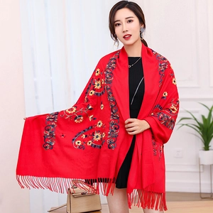 Elegant red pashmina shawl with colorful floral embroidery and fringe trim on model