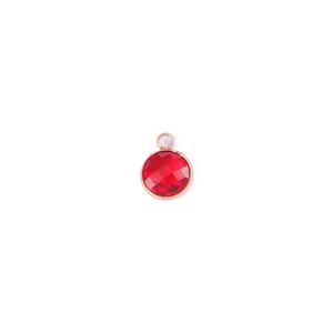 Macro detail of 7mm red birthstone charm pendant in rose gold finish for DIY jewelry