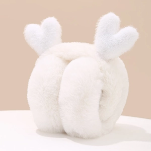 Close-up of white plush ear muffs featuring cute heart-shaped antler accents for winter