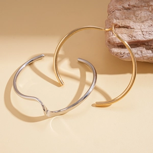 Minimalist irregular twisted wave cuff bracelets in polished gold and silver finish