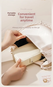 Portable cream white PU leather jewelry box being placed into a stylish woven handbag