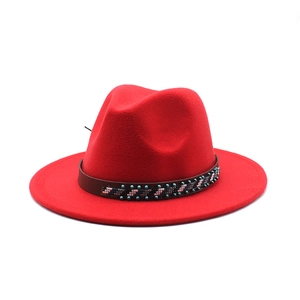 Detail of red wool felt fedora with bohemian beaded leather band and wide brim