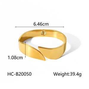 Detailed view of gold wide cuff bracelet with 6.46cm diameter and 1.08cm width dimensions