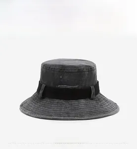 Detail of embroidered BELFRY lettering and metal eyelet on washed grey denim bucket hat