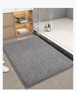 Macro detail of grey bathroom mat showing high-density spherical weave and anti-slip edge