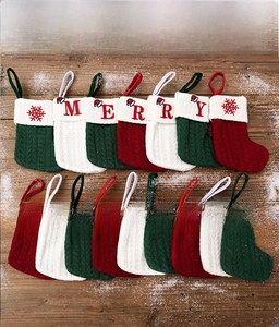 Detailed close-up of colorful knitted Christmas socks on snowy vintage wood background