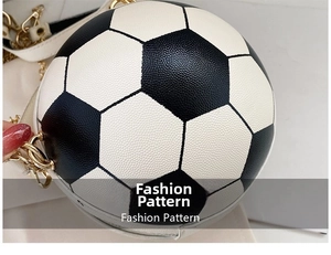Detailed close-up of soccer-shaped round handbag with black and white leather stitching
