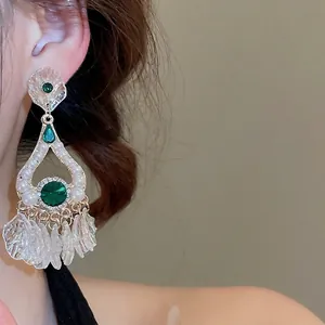Vintage palace style long earrings with green gems, white pearls and frosted petal tassels
