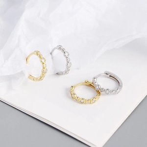 Close-up of gold and silver S925 sterling silver hoop earrings with clear zircon stones