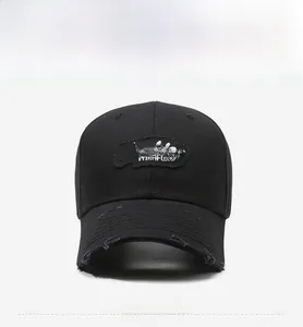 Close-up of Thinking WISHFUL embroidery and distressed ripped details on a black cotton cap
