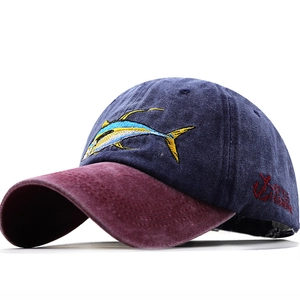 Detail of navy washed cotton baseball cap with tuna embroidery and anchor logo side detail