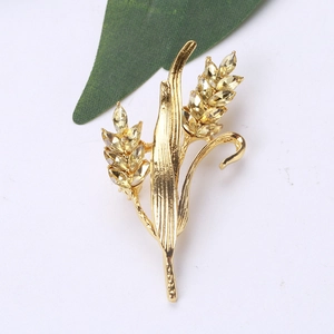 Detail showing golden wheat ear brooch with sparkling yellow crystal rhinestones