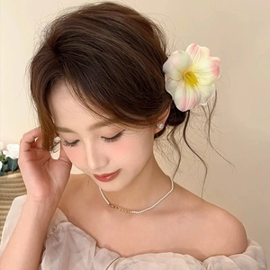 Detail of elegant pink tulip hair accessory with floral ribbons on a model's hair
