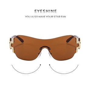 Close-up of rimless Y2K sunglasses with gradient brown lenses and rhinestone temples