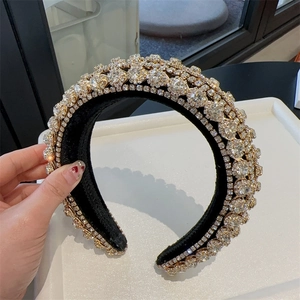 Close-up of luxury sponge headband with sparkling crystal rhinestones on black velvet