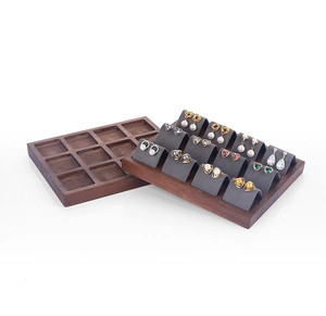 Detail view of walnut wood 12-slot jewelry tray with grey velvet earring inserts