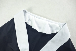 Close-up of black and white contrast notched lapel collar with high-quality knit texture