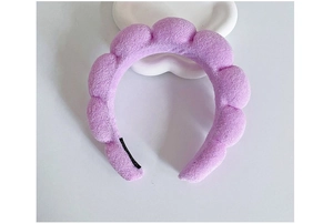 Detail of soft purple plush braided cloud headband with sponge filling on white background