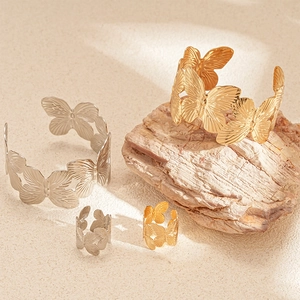 Textured butterfly open bangles and rings set in gold and silver finish on stones