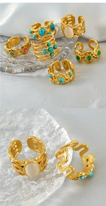 Detail of vintage gold-plated rings set with turquoise and gemstone inlay on silk