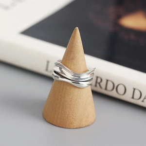 Detail of S925 sterling silver double-layered wavy ring on a wooden cone stand