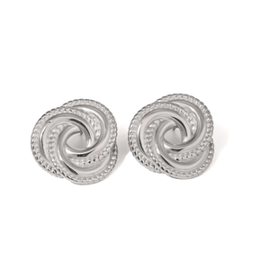 Macro shot of silver triple-layered spiral knot stud earrings in stainless steel