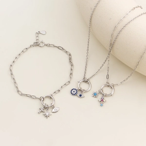 Close-up of S925 silver bracelet and necklace with blue evil eye and star charms
