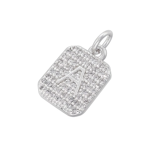 Macro shot of silver letter A pendant with sparkling cubic zirconia on white background