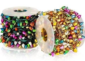 Macro shot of colorful metallic bulb-shaped bead chains on gold and green strings