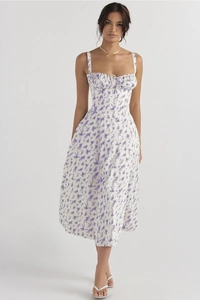 Detailed close-up of a floral summer dress featuring purple flowers and a lace-up bodice