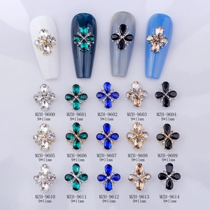 Detail of 9x11mm cross-shaped crystal nail charms in various colors with alloy base