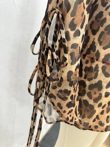 Detailed view of lightweight leopard print chiffon fabric with adjustable drawstring details