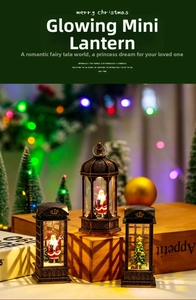 Macro detail of bronze LED Christmas lantern with miniature Santa scene and warm glow