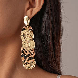 Chic leopard print and gold disc drop earrings on model for a vintage look