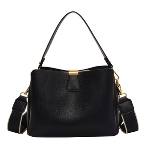 Elegant black pebbled leather bucket bag with gold hardware and wide fabric strap
