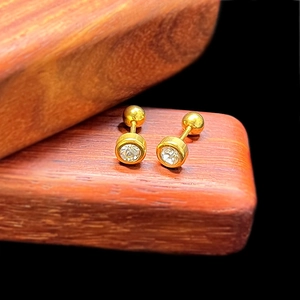 Detailed view of gold plated screw back stud earrings with sparkling cubic zirconia stones