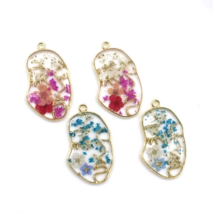 Face contour resin pendants with dried flowers in gold metal frames for DIY jewelry