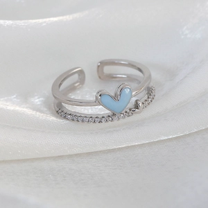 Macro view of double-layer silver ring with blue enamel heart and pavé cubic zirconia