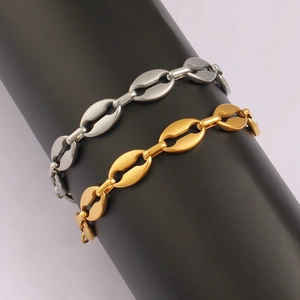 Detailed macro view of coffee bean link bracelets in polished gold and silver metal