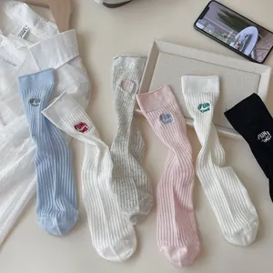 Close-up of ribbed cotton socks with 'FUN TIME' embroidery in various pastel colors